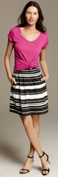 pink buttoned buttoned tee with black and white striped knee length skirt