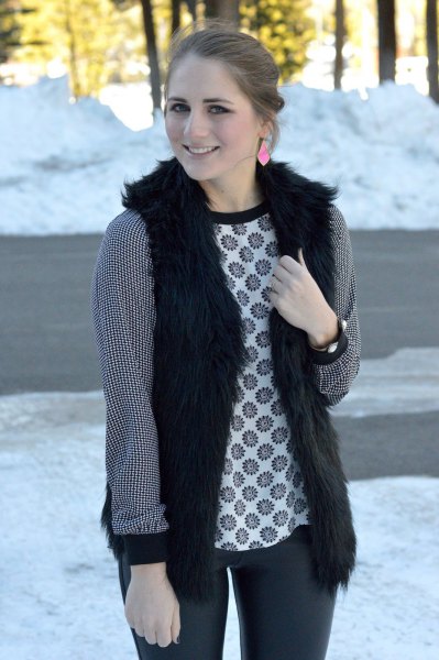 black vest with stem printed long sleeve top and dark gray jeans
