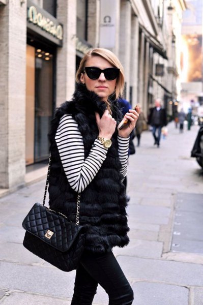 white and black striped long-sleeved t-shirt with fur vest and slim fit jeans