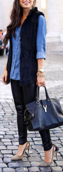 blue chambray button up shirt with black longline fur vest