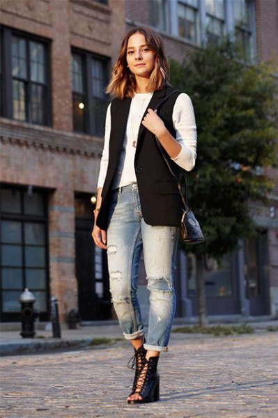 black sleeveless jacket with white long sleeve tee and cuffed boyfriend jeans