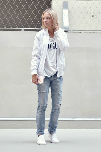 pure white bomber jacket with print shirt and blue jeans with straight legs