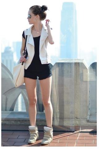white sleeveless blazer with black mini shorts and blush sneakers
