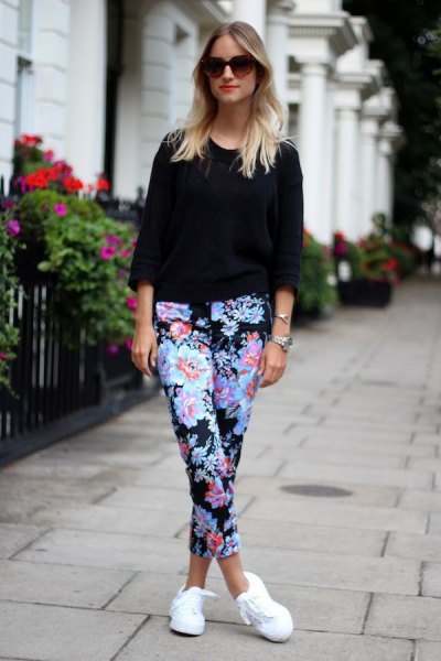 black knit black sweater with blue floral printed crop pants and white sneakers