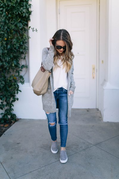 longline knitted sweater cardigan with blue jeans and gray slip on platform shoe