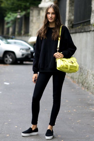 black knit sweater with crew neck with lemon yellow leather shoulder bag