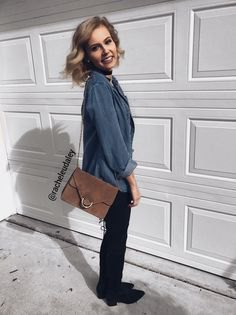 gray blue button up shirt with black slim fit jeans and gray suede shoulder bag