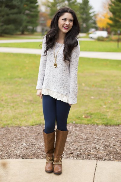Heather gray tunic sweater with dark blue leggings and brown knee high boots