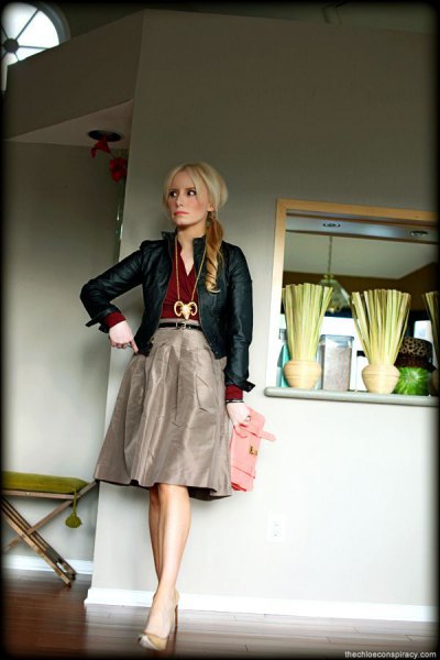 black leather jacket with gray knee length taffeta skirt