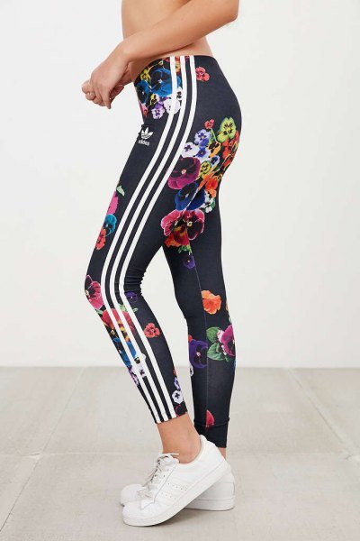 black floral adidas leggings and white running shoes
