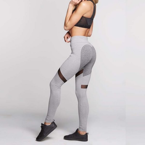 black crop top with light gray sports leggings and sneakers