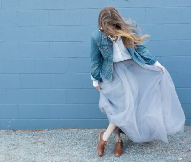 blue denim jacket with white shirt with buttons and light blue tulle maxi skirt