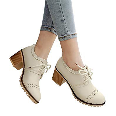 Wingtip shoes with ivory heel and light blue skinny jeans