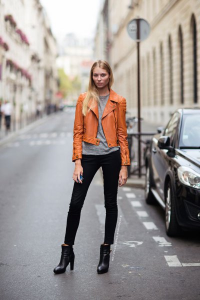 brown leather jacket with gray t-shirt and black skinny jeans