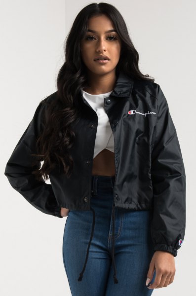 black windbreaker with white graphic t-shirt and high skinny jeans