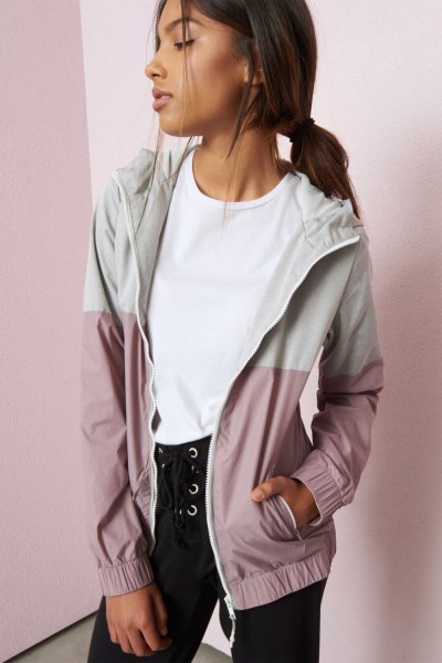 white and light gray color block Nike windbreaker with black lace jeans