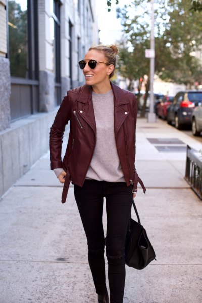 Burgundy leather jacket with gray t-shirt and black skinny jeans