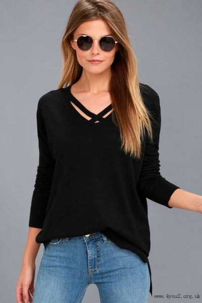 black sweater with v-neck and light blue skinny jeans