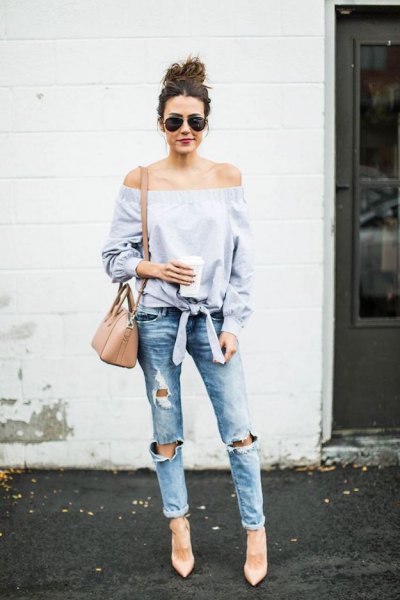 light blue, off-the-shoulder, knotted blouse with torn boyfriend jeans