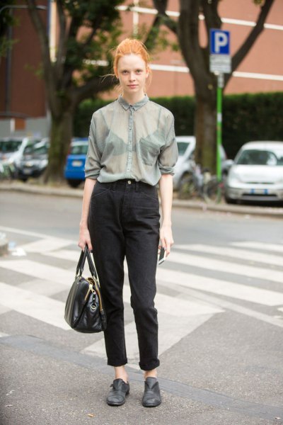 gray, semi-transparent shirt with buttons and black mom jeans with cuffs