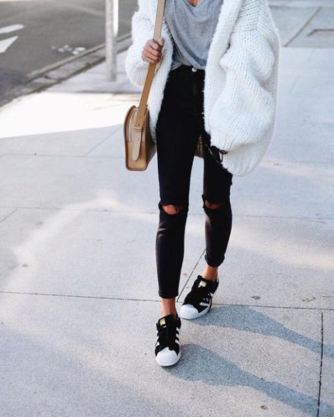 white, ribbed, thick cardigan sweater with a gray, oversized t-shirt and black jeans