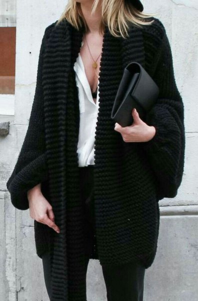 black, chunky cardigan with white blouse and clutch