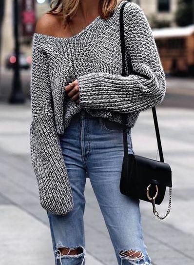 gray oversized knit sweater with one shoulder and torn boyfriend jeans