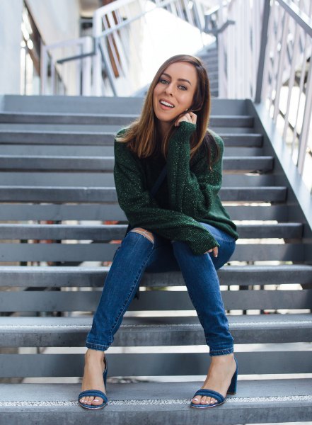 green, chunky sweater with blue torn skinny jeans