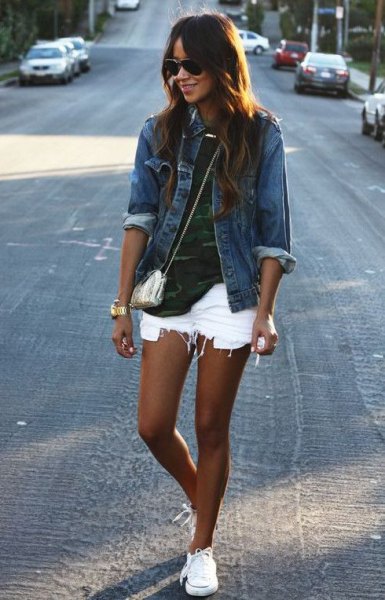 blue denim jacket with camouflage shirt and torn white denim shorts