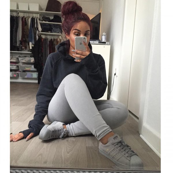 black hoodie with light gray leggings and white sneakers