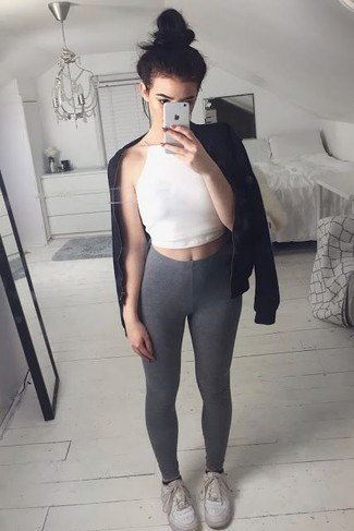 white crop top with black leather jacket and gray leggings