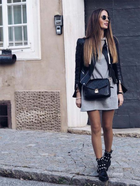black leather jacket with gray mini hoodie dress and studded combat boots