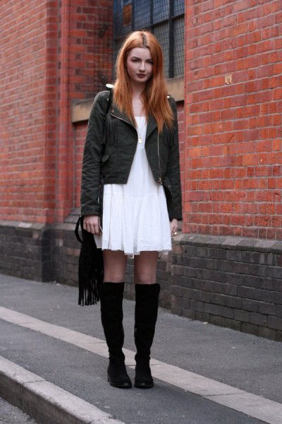 white mini dress with black jacket and boots