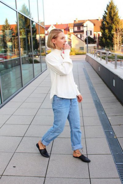 white blouse with blue torn boyfriend jeans