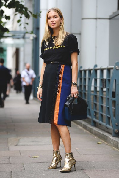 black graphic t-shirt with high midi skirt and gold boots