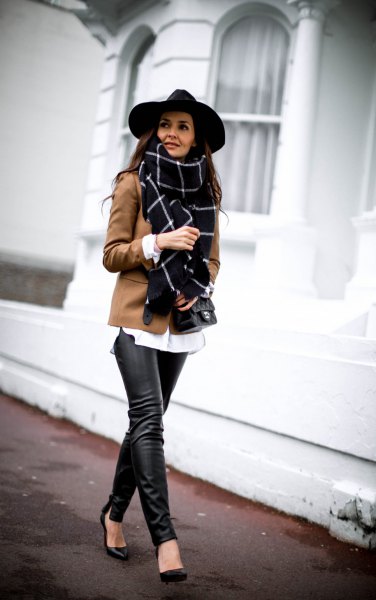 black felt hat and brown blazer and leather leggings