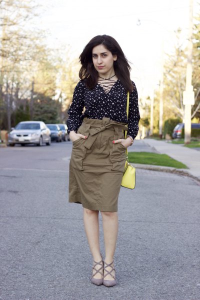 black and white polka dot blouse with green cargo high skirt