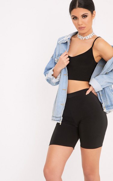 blue denim jacket with black crop top and high waisted shorts