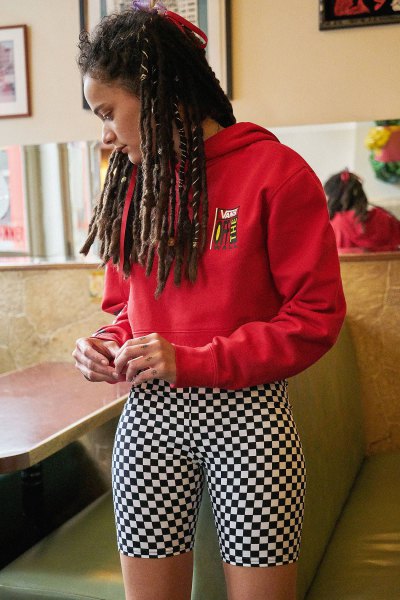 red graphic hoodie with black and white checked biker shorts