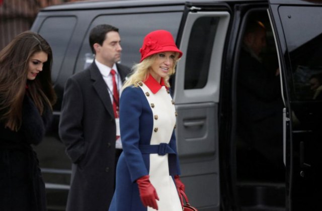 red bush hat with white and blue coat dress with belt