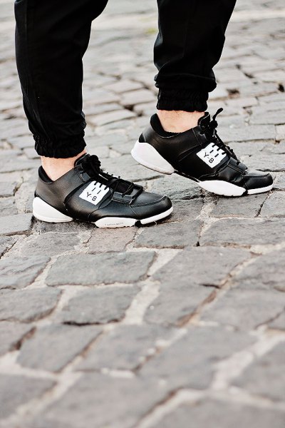 black jogger pants with leather running shoes