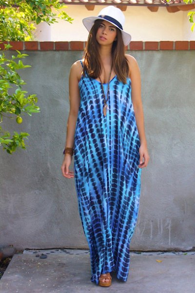 blue and white sleeveless maxi dress with floppy hat