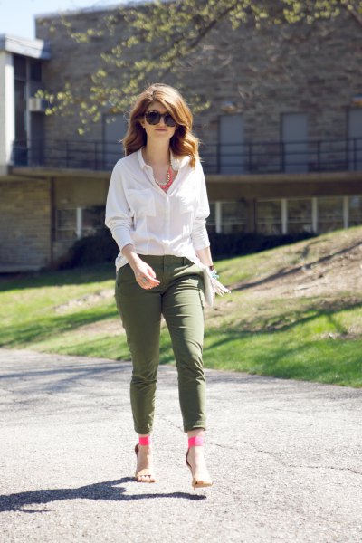 white blouse with buttons and army green ankle pants