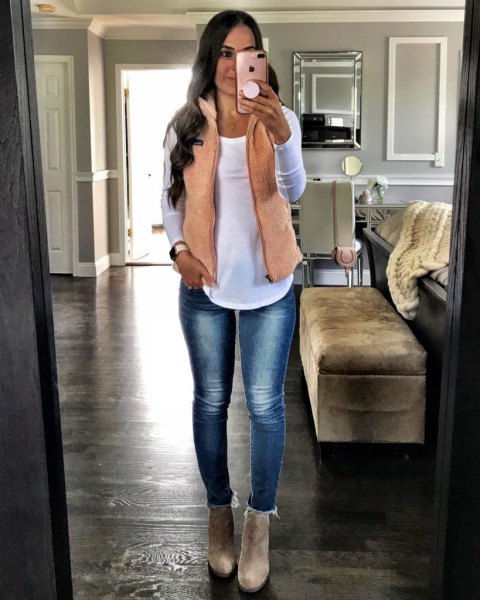 blushing pink vest with white long-sleeved t-shirt and slim jeans lined with fleece