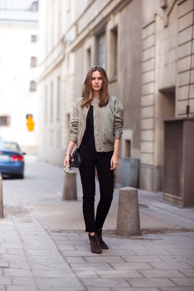 gray pilot jacket with black ankle jeans and suede boots