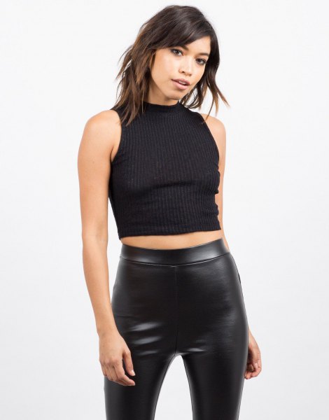 black sleeveless, ribbed, short-cut sweater with leather gaiters