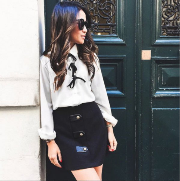 white bow tie blouse with black high rise mini skirt