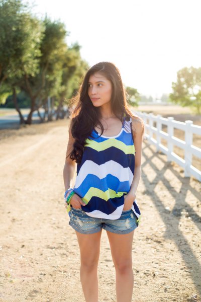 blue and light yellow tank top with zigzag print and mini denim shorts
