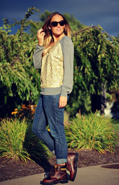 gray sweatshirt with gold vest and blue jeans with cuff