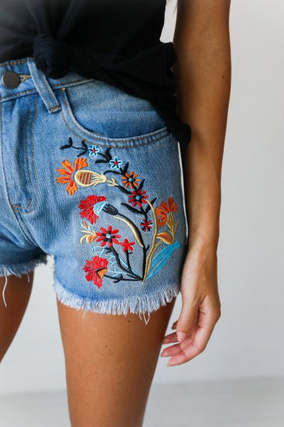 black tank top with blue, embroidered floral denim shorts